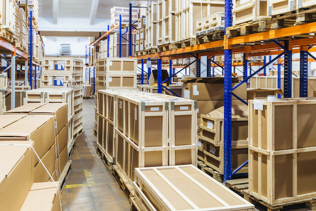 Rows of shelves filled with cardboard boxes. Warehouse transport and logistics company. Storage of retail. Large hangar. Big containers. Goods inside.